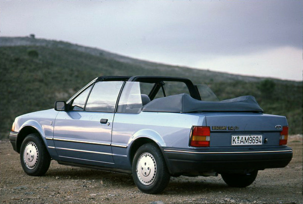 This archival image documents the 1986 Ford Escort Mark IV 1.6 Ghia Cabriolet rear view with scenic hills and is preserved in the Ford Heritage Vault as part of Ford Motor Company's historic photographic archive. Free for personal, non-commercial ...