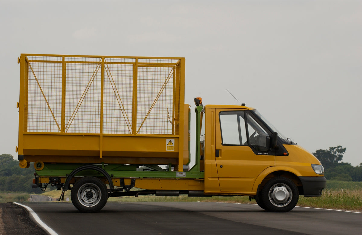 This archival image documents the 2003 Ford Transit Mark IV conversion with wire container side view on scenic road and is preserved in the Ford Heritage Vault as part of Ford Motor Company's historic photographic archive. Free for personal, non-c...
