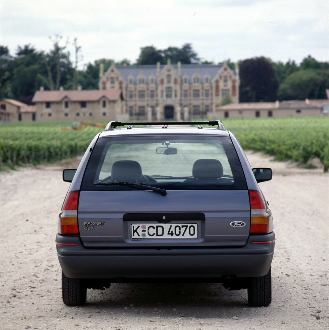 This archival image documents the 1990 Ford Escort Mark IV Estate rear view in front of scenic mansion and is preserved in the Ford Heritage Vault as part of Ford Motor Company's historic photographic archive. Free for personal, non-commercial use...