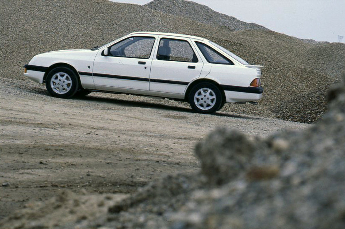 This archival image documents the 1985 Ford Sierra XR 4x4 LHD side view in gravel pit and is preserved in the Ford Heritage Vault as part of Ford Motor Company's historic photographic archive. Free for personal, non-commercial use. Ford Heritage V...