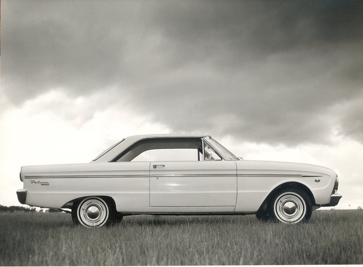 This archival image documents the 1964 Ford XM Falcon 2 Door Hardtop low side view in scenic field and is preserved in the Ford Heritage Vault as part of Ford Motor Company's historic photographic archive. Free for personal, non-commercial use. Fo...