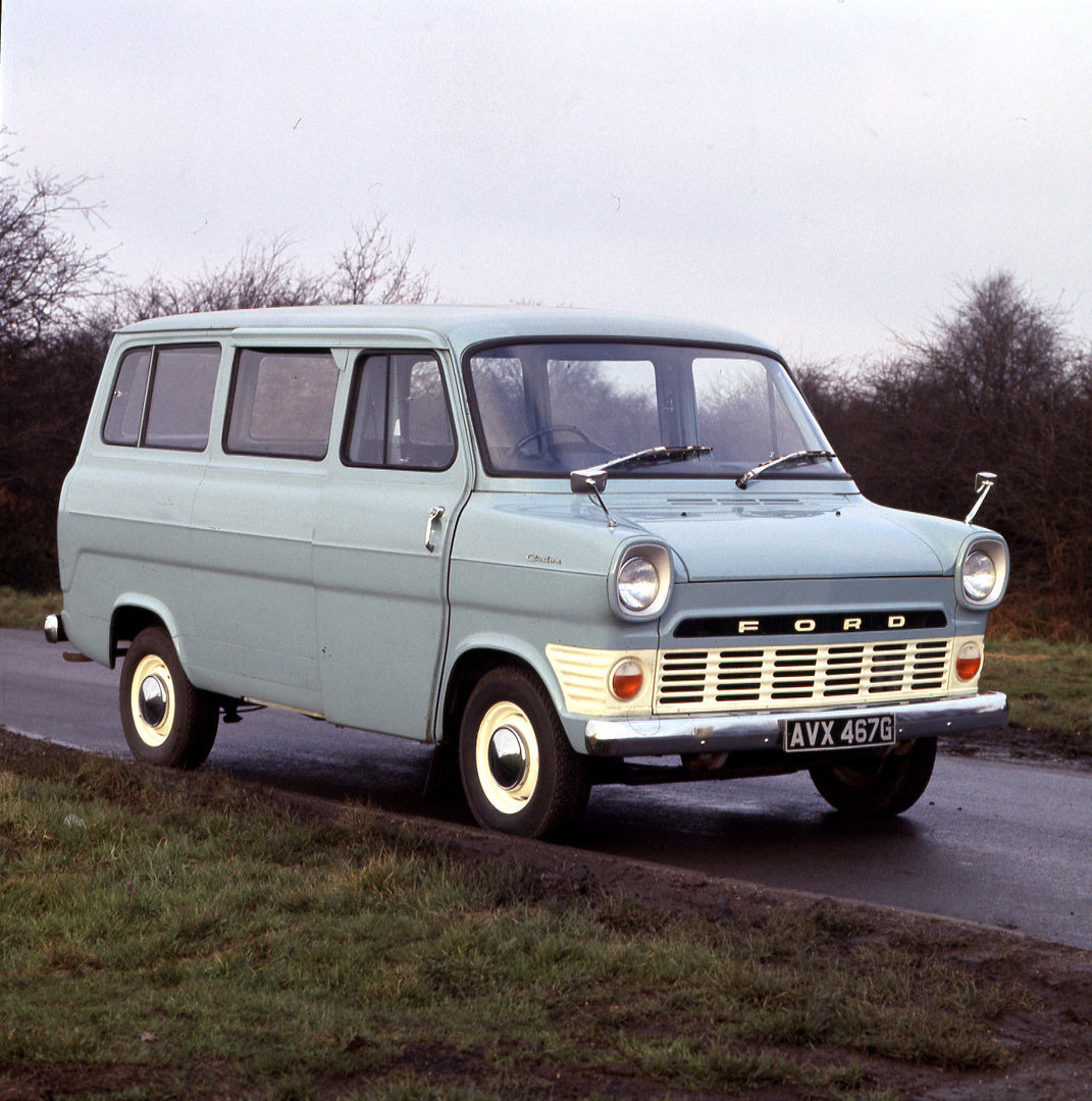 This archival image documents the 1969 Ford Transit Mark I Custom 12 Seater Bus on scenic road and is preserved in the Ford Heritage Vault as part of Ford Motor Company's historic photographic archive. Free for personal, non-commercial use. Ford H...