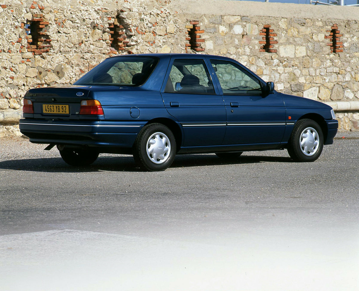 This archival image documents the 1994 Ford Escort Mark V rear view with scenic rock wall and is preserved in the Ford Heritage Vault as part of Ford Motor Company's historic photographic archive. Free for personal, non-commercial use. Ford Herita...
