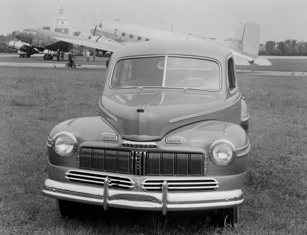 This archival image documents the 1946 Mercury Two-Door Sedan Airplanes And People In Background and is preserved in the Ford Heritage Vault as part of Ford Motor Company's historic photographic archive. Free for personal, non-commercial use. Ford...