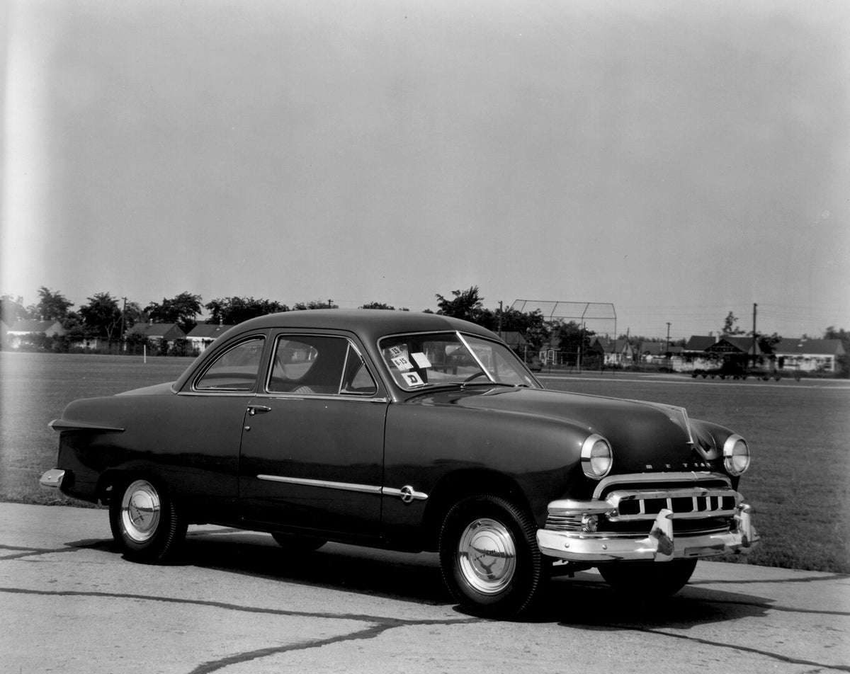 This archival image documents the 1951 Meteor Coupe on road with houses in distance AR-2007-5 and is preserved in the Ford Heritage Vault as part of Ford Motor Company's historic photographic archive. Free for personal, non-commercial use. Ford He...