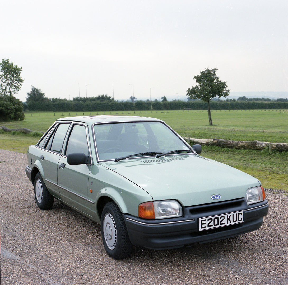 This archival image documents the 1987 Ford Escort Mark IV Ghia 1.6 on scenic road and is preserved in the Ford Heritage Vault as part of Ford Motor Company's historic photographic archive. Free for personal, non-commercial use. Ford Heritage Vaul...