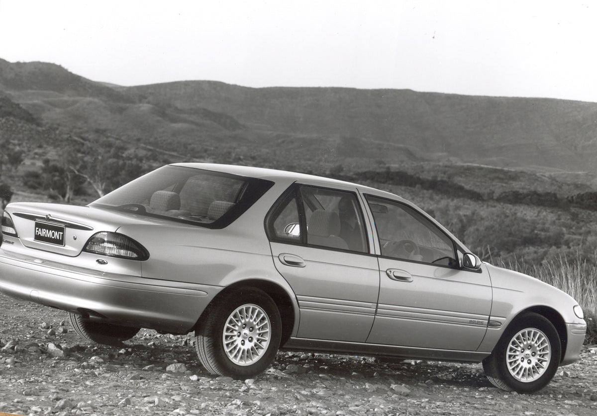 This archival image documents the 1994 Ford Falcon EF Fairmont rear view with scenic mountains and is preserved in the Ford Heritage Vault as part of Ford Motor Company's historic photographic archive. Free for personal, non-commercial use. Ford H...
