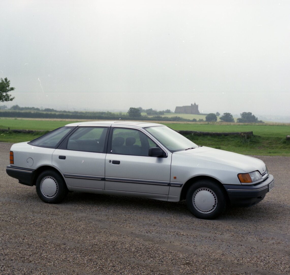 This archival image documents the 1987 Ford Granada Mark III GL side view on scenic road and is preserved in the Ford Heritage Vault as part of Ford Motor Company's historic photographic archive. Free for personal, non-commercial use. Ford Heritag...