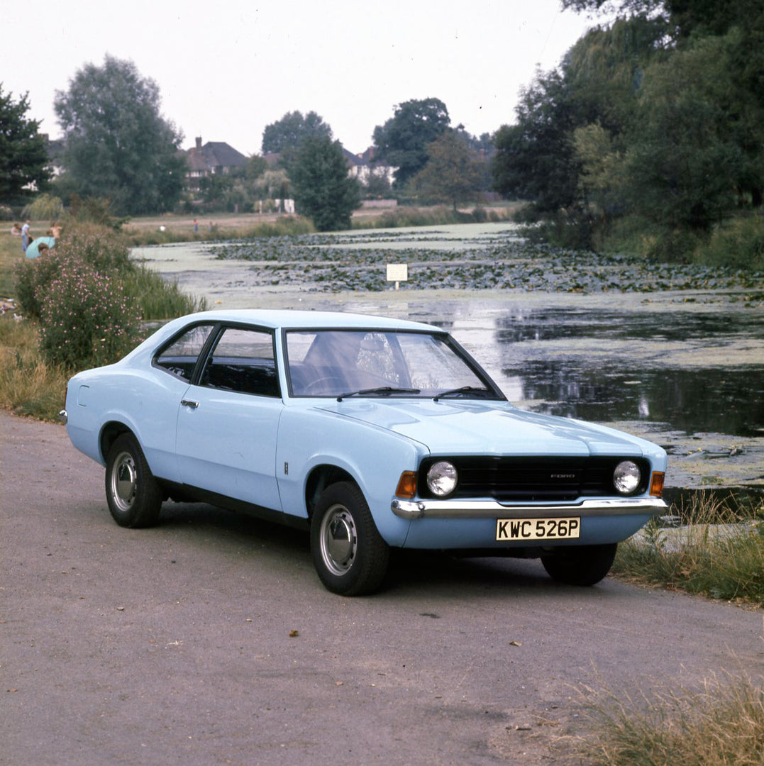 This archival image documents the 1975 Ford Cortina 1.3 Base MK III 2 on scenic road with marshy river and is preserved in the Ford Heritage Vault as part of Ford Motor Company's historic photographic archive. Free for personal, non-commercial use...