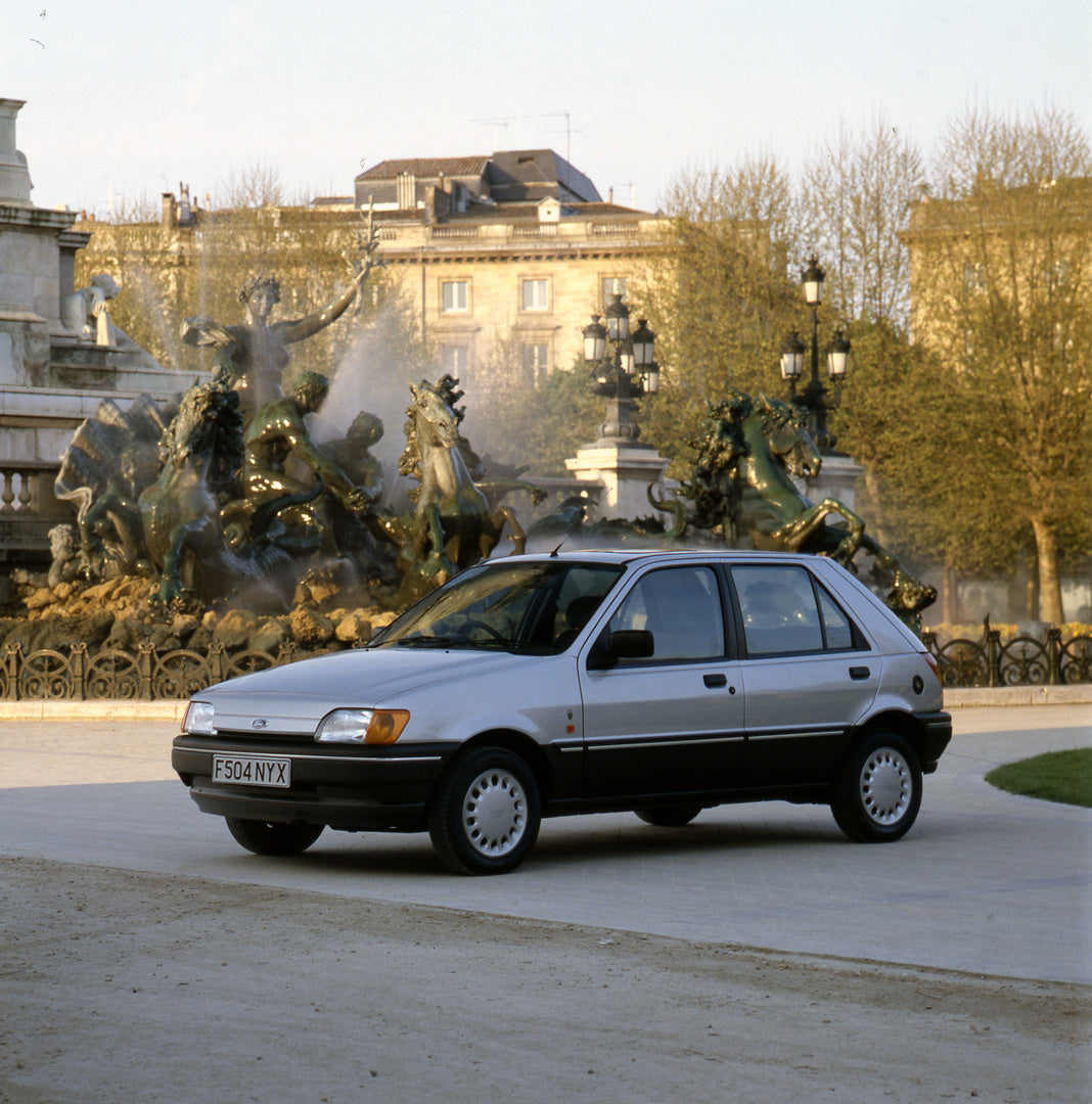 This archival image documents the 1989 Ford Fiesta Mark III Ghia in front of scenic fountain in Bordeaux, France and is preserved in the Ford Heritage Vault as part of Ford Motor Company's historic photographic archive. Free for personal, non-comm...