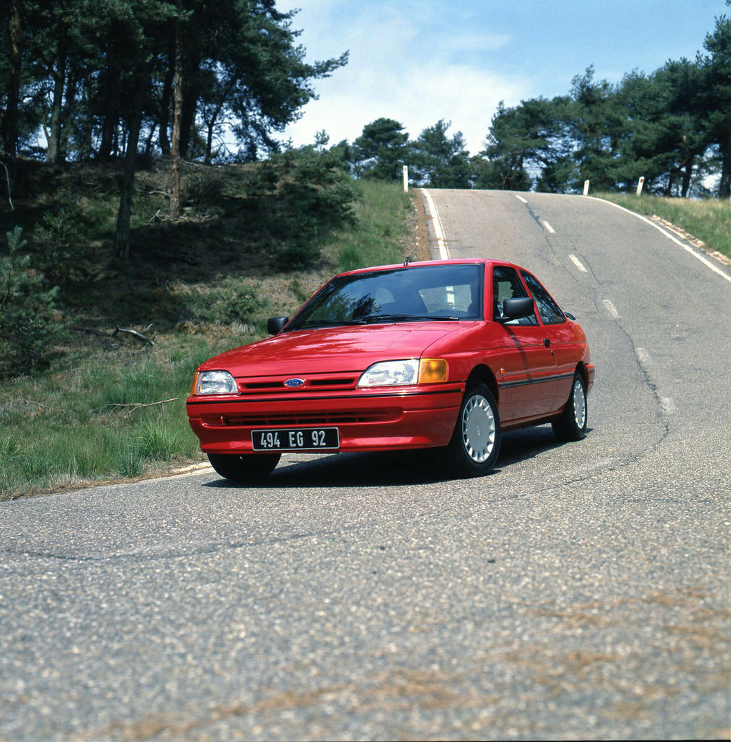 This archival image documents the 1990 Ford Escort S Mark IV on road in Lommel, Belgium and is preserved in the Ford Heritage Vault as part of Ford Motor Company's historic photographic archive. Free for personal, non-commercial use. Ford Heritage...