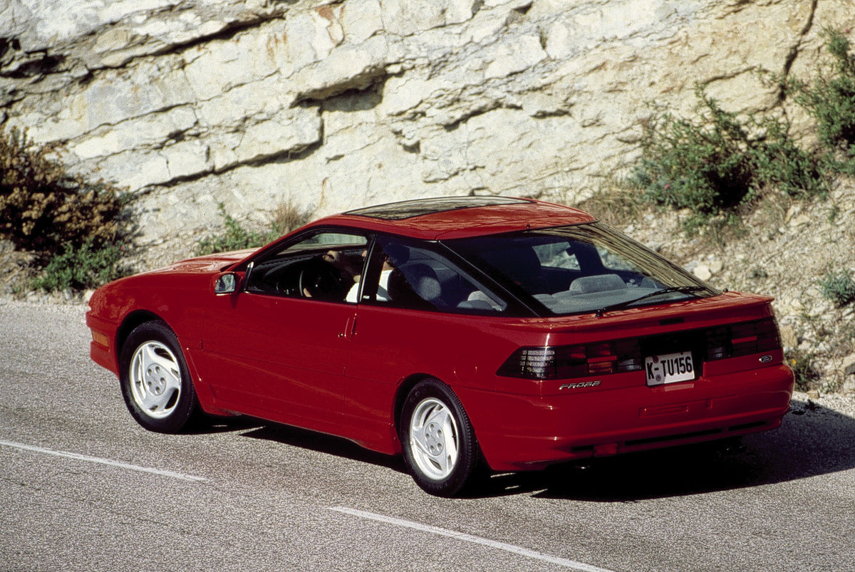 This archival image documents the 1991 Ford Probe rear view on scenic road with rock formations and is preserved in the Ford Heritage Vault as part of Ford Motor Company's historic photographic archive. Free for personal, non-commercial use. Ford ...