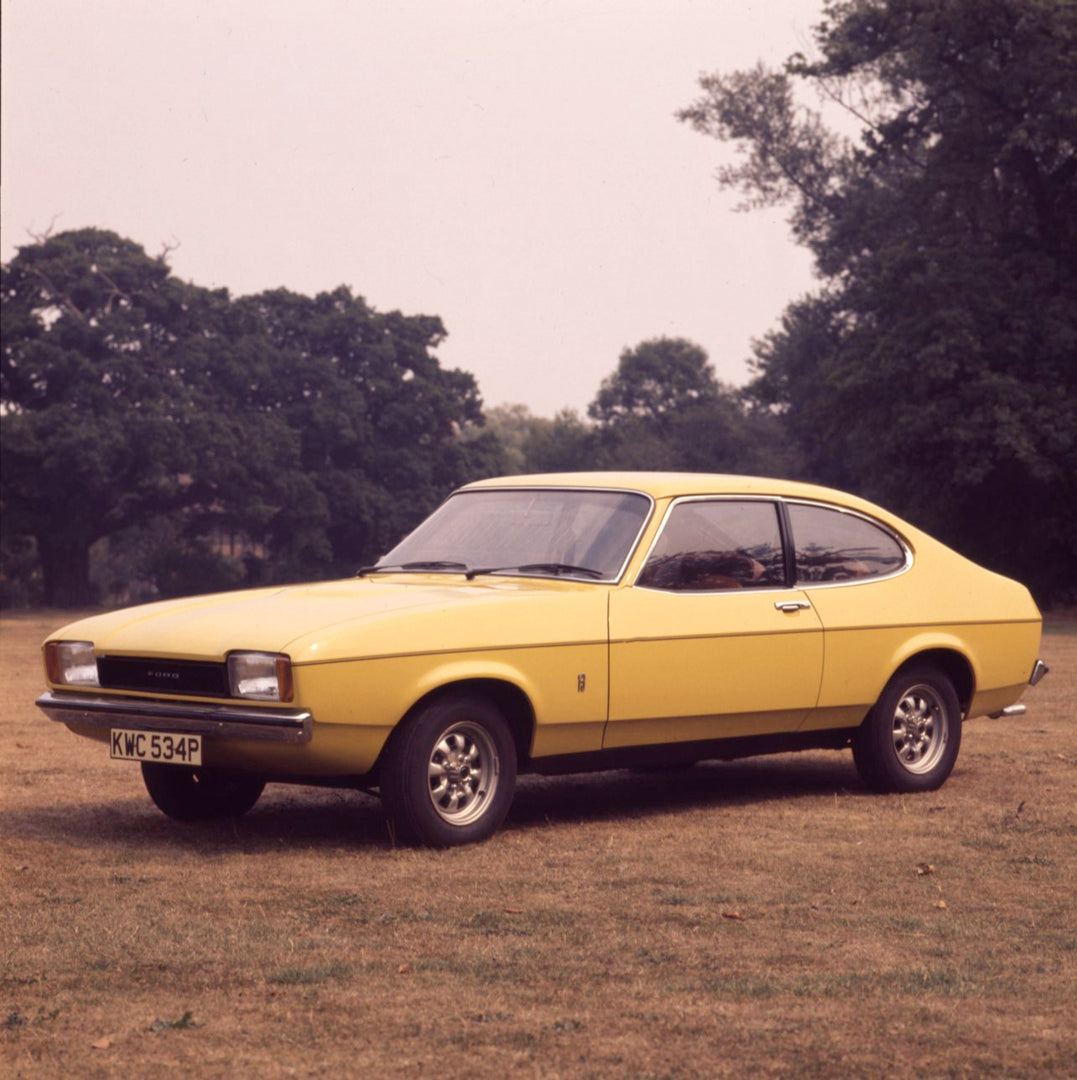 This archival image documents the 1975 Ford Capri MK II 1.3 L in scenic field and is preserved in the Ford Heritage Vault as part of Ford Motor Company's historic photographic archive. Free for personal, non-commercial use. Ford Heritage Vault ref...
