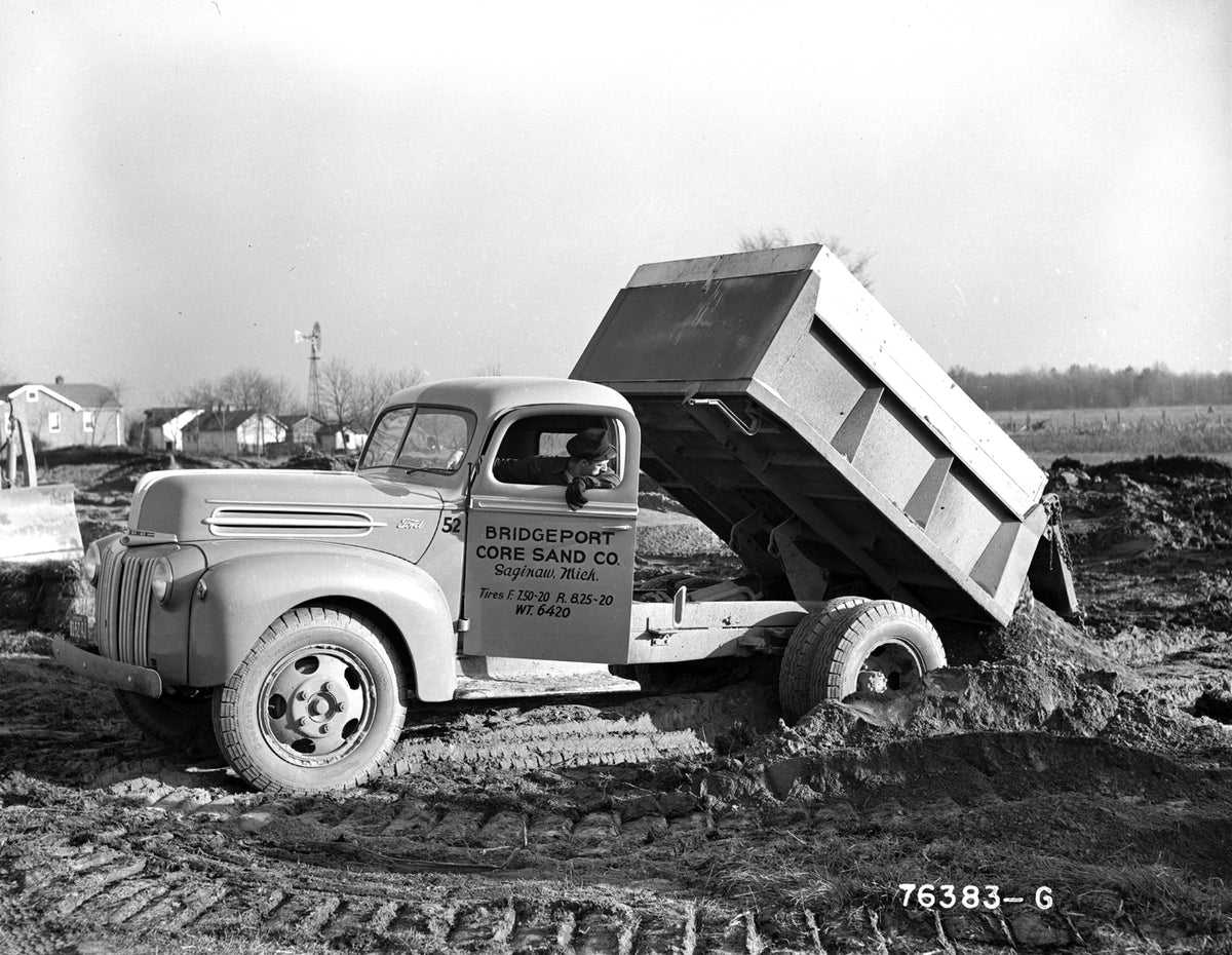This archival image documents the 1942 Ford dump truck at construction site and is preserved in the Ford Heritage Vault as part of Ford Motor Company's historic photographic archive. Free for personal, non-commercial use. Ford Heritage Vault refer...
