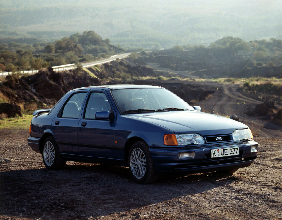This archival image documents the 1987 Ford Sierra Cosworth LHD on scenic dirt road and is preserved in the Ford Heritage Vault as part of Ford Motor Company's historic photographic archive. Free for personal, non-commercial use. Ford Heritage Vau...