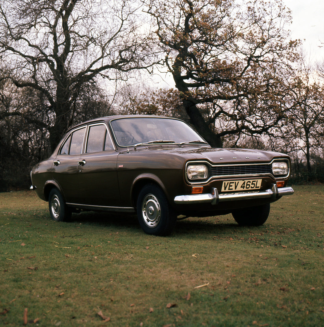 This archival image documents the 1972 Ford Escort Mark I 1300 GT 4 Door with scenic trees and is preserved in the Ford Heritage Vault as part of Ford Motor Company's historic photographic archive. Free for personal, non-commercial use. Ford Herit...