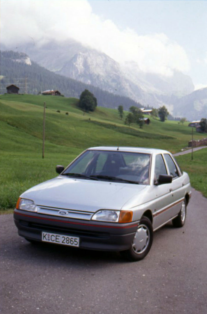 This archival image documents the 1990 Ford Escort GLX Mark IV on scenic road in Geneva, Switzerland and is preserved in the Ford Heritage Vault as part of Ford Motor Company's historic photographic archive. Free for personal, non-commercial use. ...