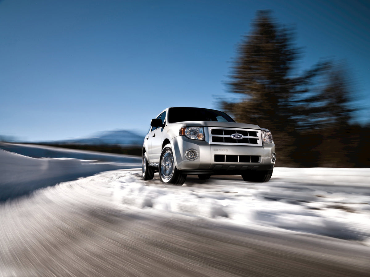 This archival image documents the 2009 Ford Escape in snow and is preserved in the Ford Heritage Vault as part of Ford Motor Company's historic photographic archive. Free for personal, non-commercial use. Ford Heritage Vault reference AR-2008-8.1....
