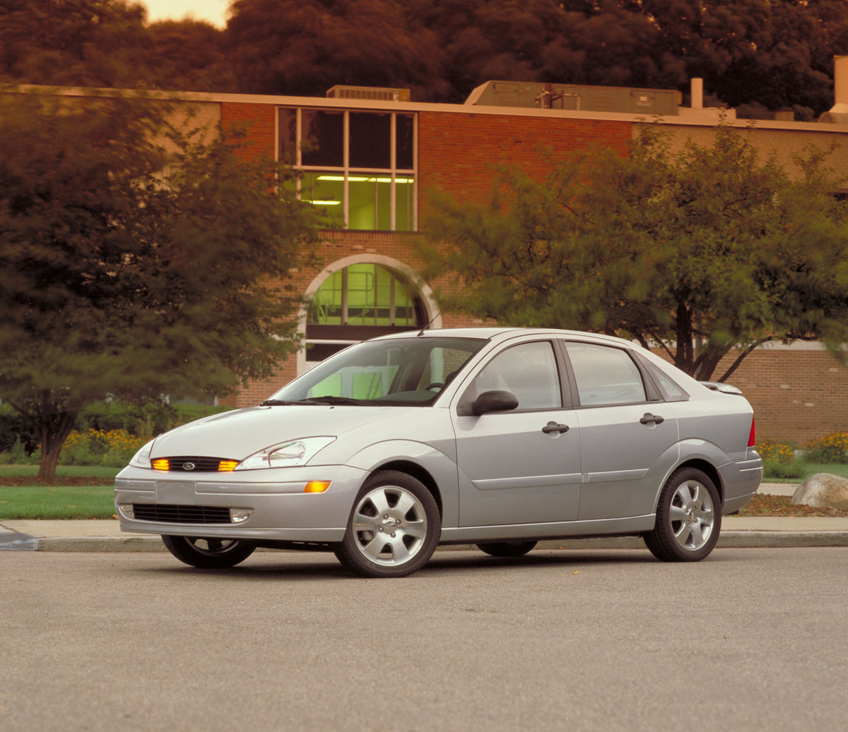 This archival image documents the 2002 Ford Focus ZTS in front of building with scenic trees MS331 and is preserved in the Ford Heritage Vault as part of Ford Motor Company's historic photographic archive. Free for personal, non-commercial use. Fo...