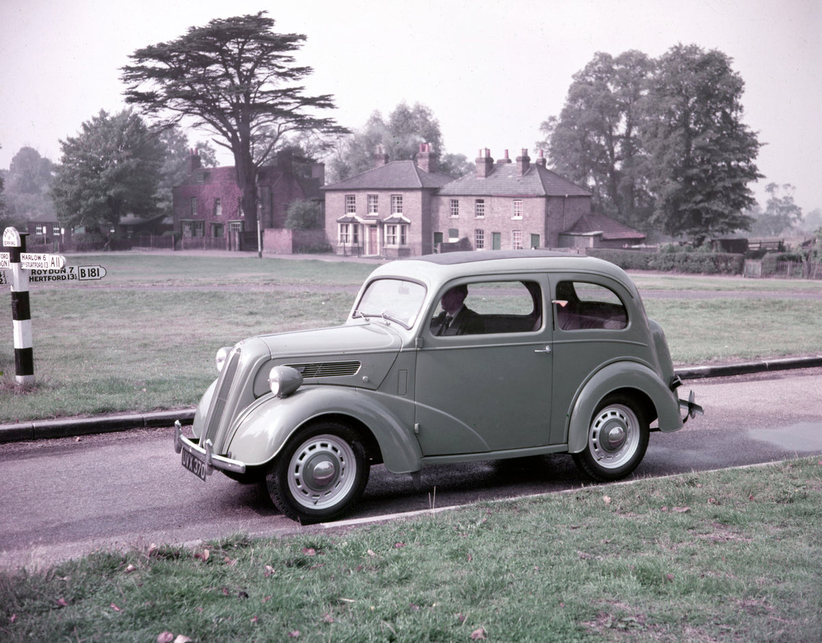 This archival image documents the 1953 Ford Popular 103E side view on scenic road with houses and is preserved in the Ford Heritage Vault as part of Ford Motor Company's historic photographic archive. Free for personal, non-commercial use. Ford He...