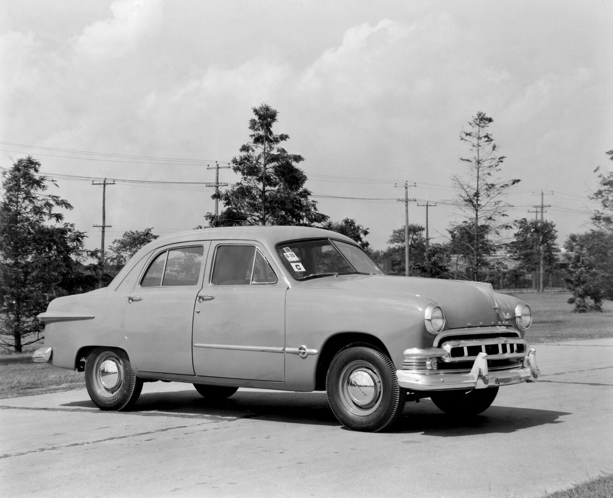 This archival image documents the 1951 Meteor Sedan on scenic road with trees AR-2007-5 and is preserved in the Ford Heritage Vault as part of Ford Motor Company's historic photographic archive. Free for personal, non-commercial use. Ford Heritage...