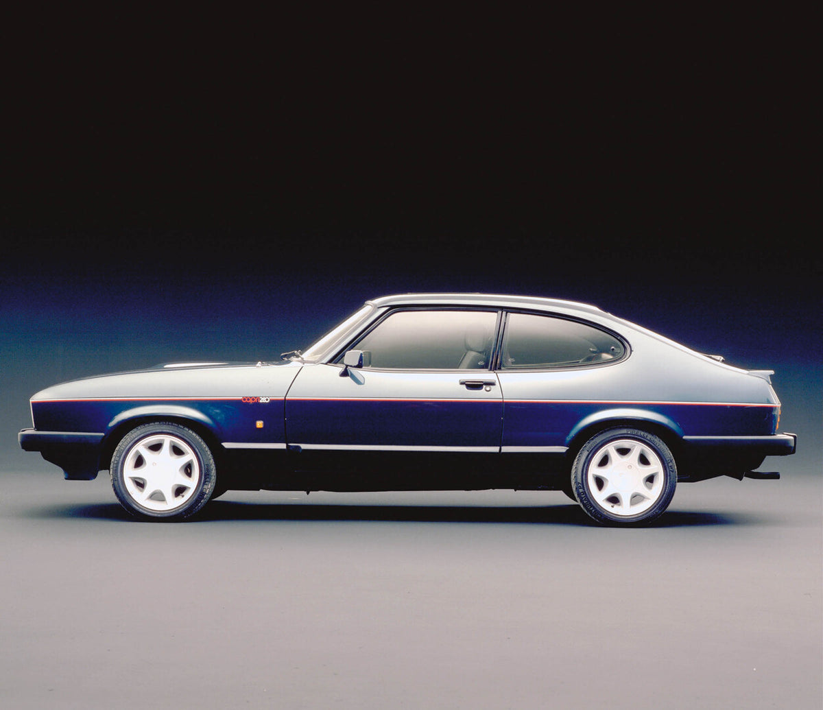This archival image documents the 1987 Ford Capri Mark III side view in studio and is preserved in the Ford Heritage Vault as part of Ford Motor Company's historic photographic archive. Free for personal, non-commercial use. Ford Heritage Vault re...