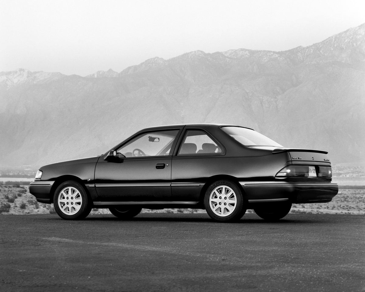 This archival image documents the 1992 Mercury Topaz Side View and is preserved in the Ford Heritage Vault as part of Ford Motor Company's historic photographic archive. Free for personal, non-commercial use. Ford Heritage Vault reference AR-2008-...