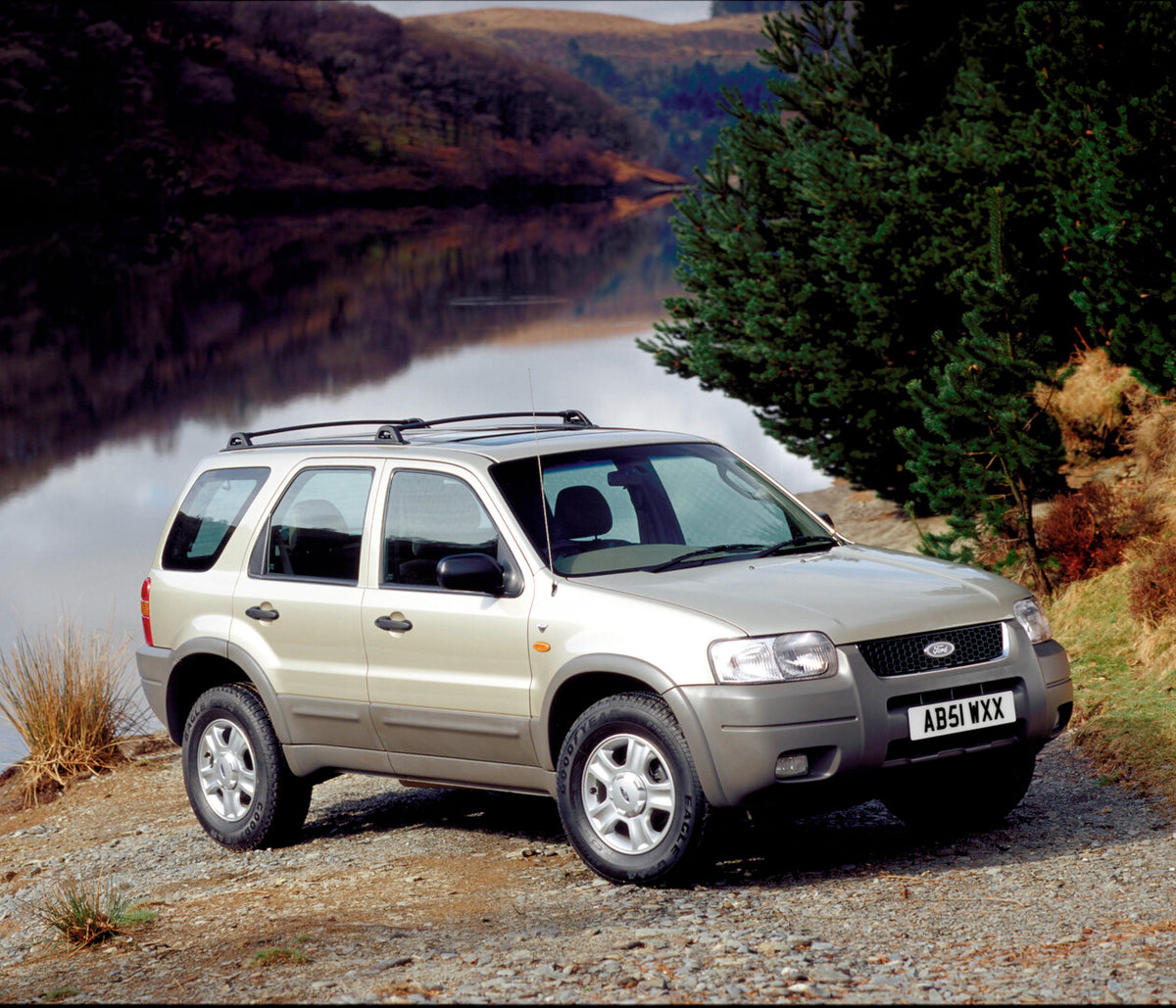 This archival image documents the 2002 Ford Maverick near scenic lake with mountains and is preserved in the Ford Heritage Vault as part of Ford Motor Company's historic photographic archive. Free for personal, non-commercial use. Ford Heritage Va...