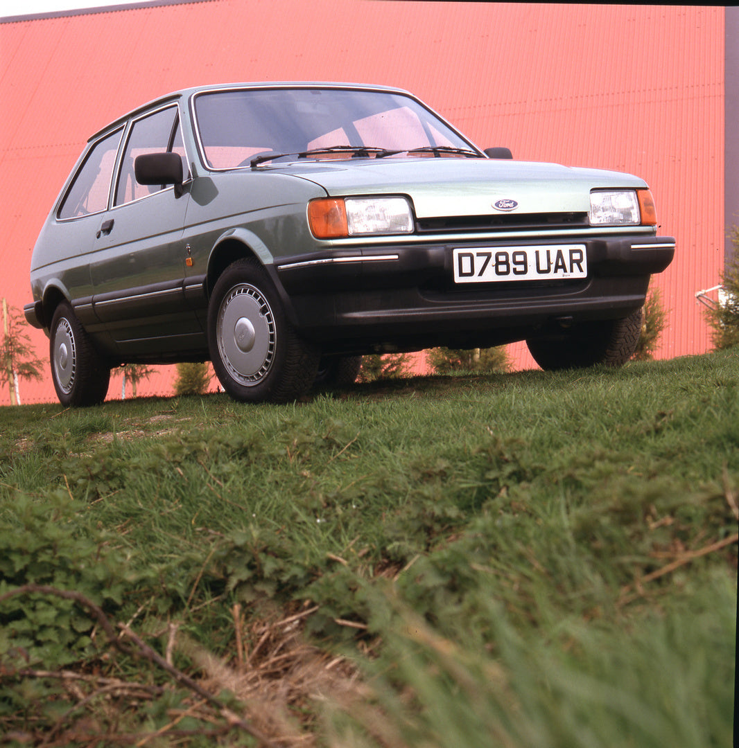 This archival image documents the 1987 Ford Fiesta Mark II CTX on grass with red roof in background and is preserved in the Ford Heritage Vault as part of Ford Motor Company's historic photographic archive. Free for personal, non-commercial use. F...