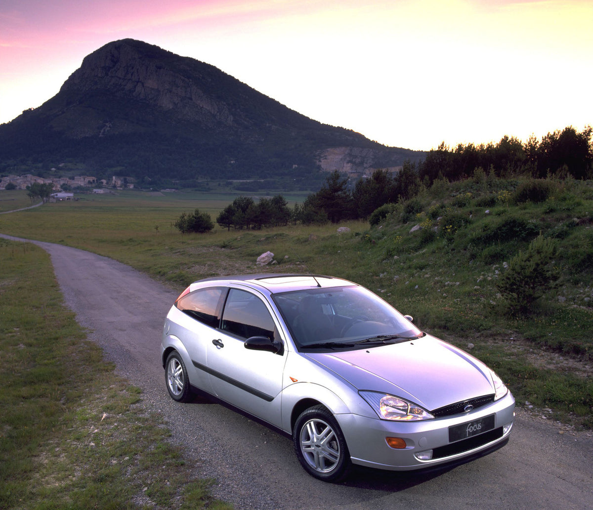 This archival image documents the 1998 Ford Focus on scenic road with mountain and is preserved in the Ford Heritage Vault as part of Ford Motor Company's historic photographic archive. Free for personal, non-commercial use. Ford Heritage Vault re...