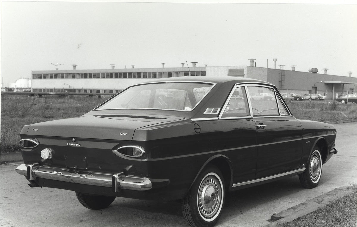 This archival image documents the 1966 Ford Taunus 12M P4 rear view on road with building and is preserved in the Ford Heritage Vault as part of Ford Motor Company's historic photographic archive. Free for personal, non-commercial use. Ford Herita...