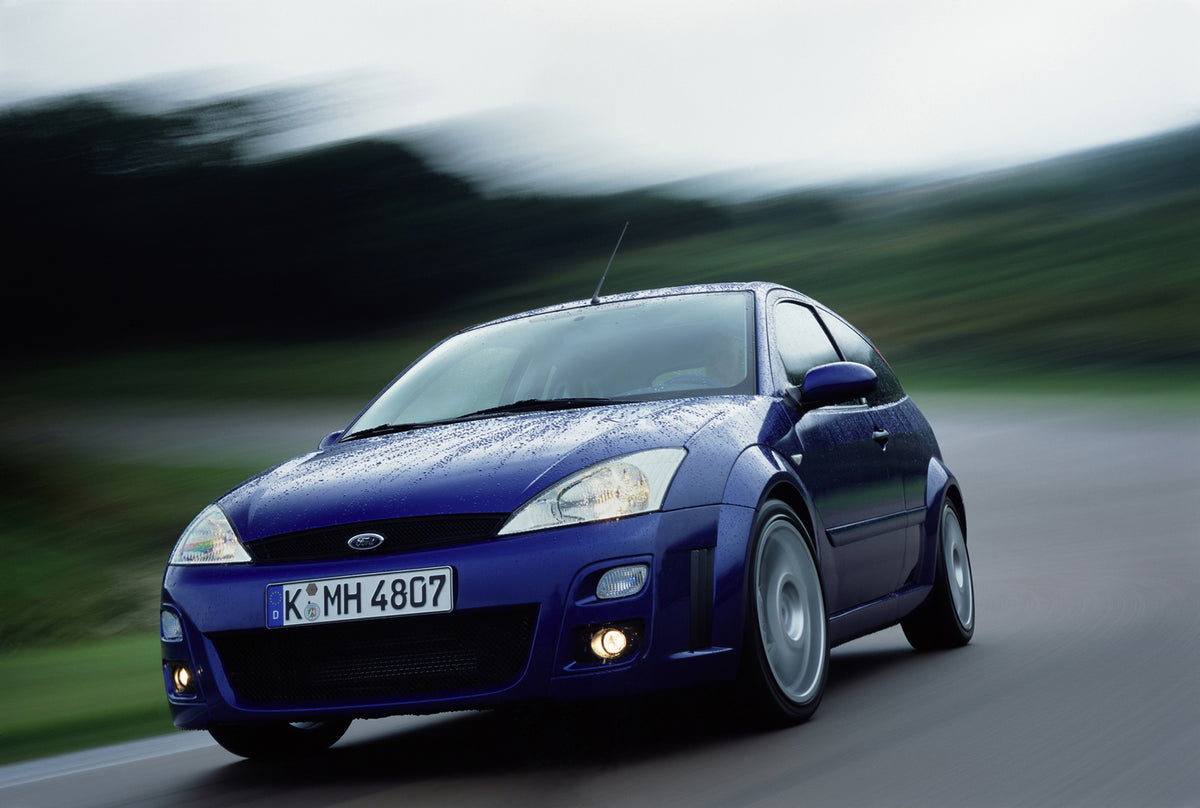 This archival image documents the 2001 Ford Focus action shot on scenic road and is preserved in the Ford Heritage Vault as part of Ford Motor Company's historic photographic archive. Free for personal, non-commercial use. Ford Heritage Vault refe...