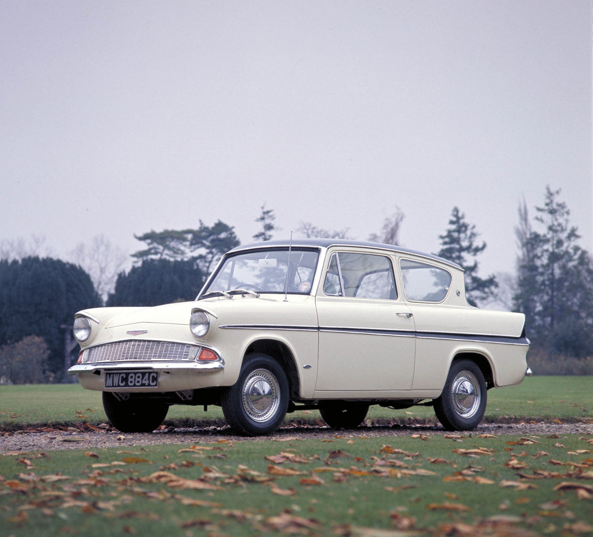 This archival image documents the 1959 Ford Anglia 105E in scenic field with trees MS9999 and is preserved in the Ford Heritage Vault as part of Ford Motor Company's historic photographic archive. Free for personal, non-commercial use. Ford Herita...