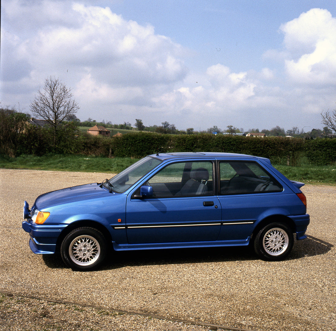 This archival image documents the 1989 Ford Fiesta Mark III RS Sport on scenic road and is preserved in the Ford Heritage Vault as part of Ford Motor Company's historic photographic archive. Free for personal, non-commercial use. Ford Heritage Vau...