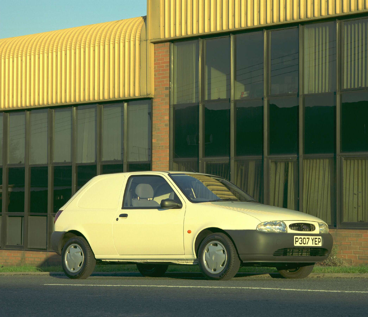 This archival image documents the 1996 Ford Fiesta Mark IV Courier 35 Van in front of building AR-2002-213709 and is preserved in the Ford Heritage Vault as part of Ford Motor Company's historic photographic archive. Free for personal, non-commerc...