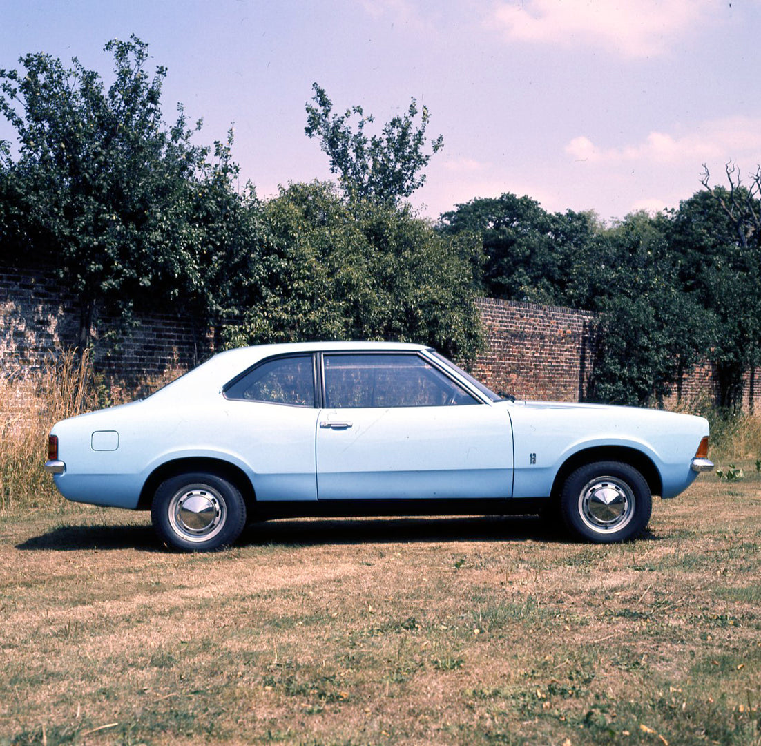 This archival image documents the 1975 Ford Cortina 1.3 Base MK III 2 door side view by scenic wall with shrubs and is preserved in the Ford Heritage Vault as part of Ford Motor Company's historic photographic archive. Free for personal, non-comme...