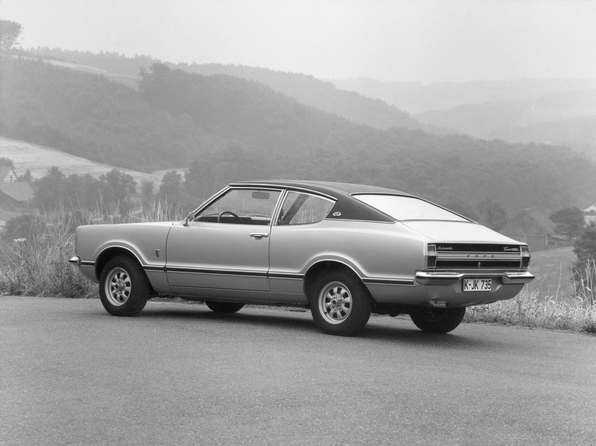 This archival image documents the 1973 Ford Taunus GXL rear view on scenic road and is preserved in the Ford Heritage Vault as part of Ford Motor Company's historic photographic archive. Free for personal, non-commercial use. Ford Heritage Vault r...