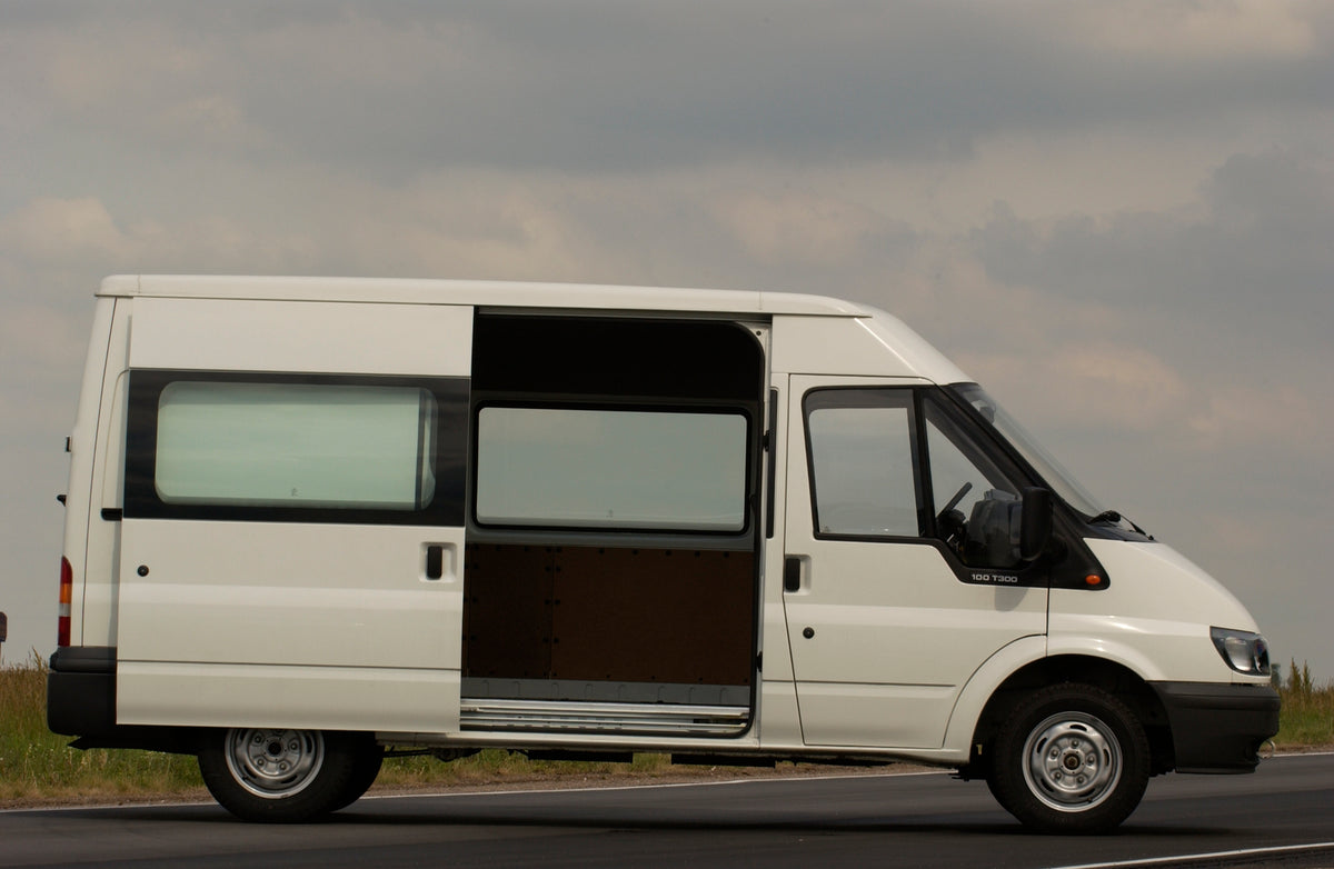 This archival image documents the 2003 Ford Transit Mark IV side view with open door on scenic road and is preserved in the Ford Heritage Vault as part of Ford Motor Company's historic photographic archive. Free for personal, non-commercial use. F...