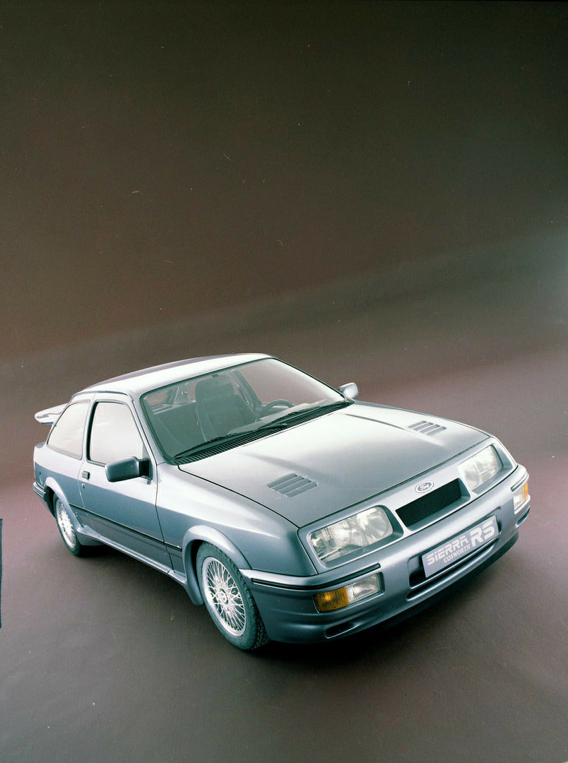 This archival image documents the 1985 Ford Sierra RS Cosworth front angled view in studio and is preserved in the Ford Heritage Vault as part of Ford Motor Company's historic photographic archive. Free for personal, non-commercial use. Ford Herit...