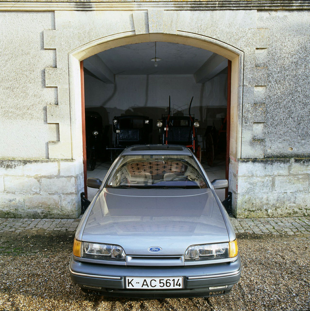 This archival image documents the 1985 Ford Scorpio Mark I front view in front of garage in Bordeaux and is preserved in the Ford Heritage Vault as part of Ford Motor Company's historic photographic archive. Free for personal, non-commercial use. ...