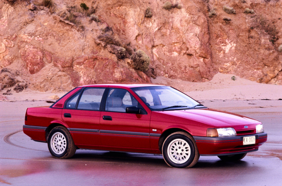 This archival image documents the 1988 Ford EA Falcon Sedan Driver Side Front End View on the Beach FAP-2011-3 and is preserved in the Ford Heritage Vault as part of Ford Motor Company's historic photographic archive. Free for personal, non-commer...