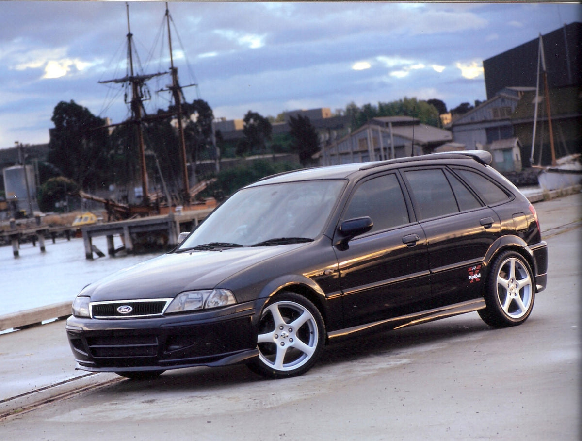 This archival image documents the 2001 Ford Laser SR2 Turbo on scenic dock with ship and is preserved in the Ford Heritage Vault as part of Ford Motor Company's historic photographic archive. Free for personal, non-commercial use. Ford Heritage Va...
