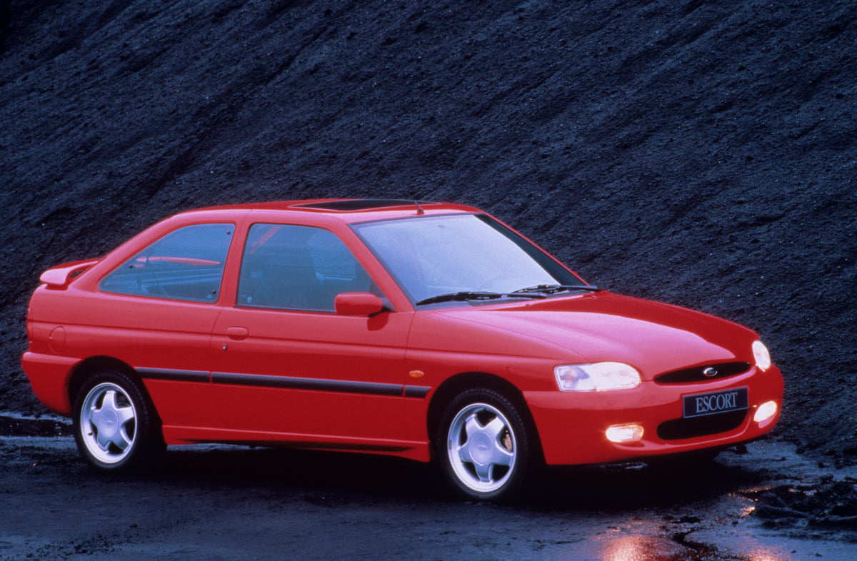 This archival image documents the 1995 Ford Escort Mark V RS2000 closeup with scenic rock formation and is preserved in the Ford Heritage Vault as part of Ford Motor Company's historic photographic archive. Free for personal, non-commercial use. F...