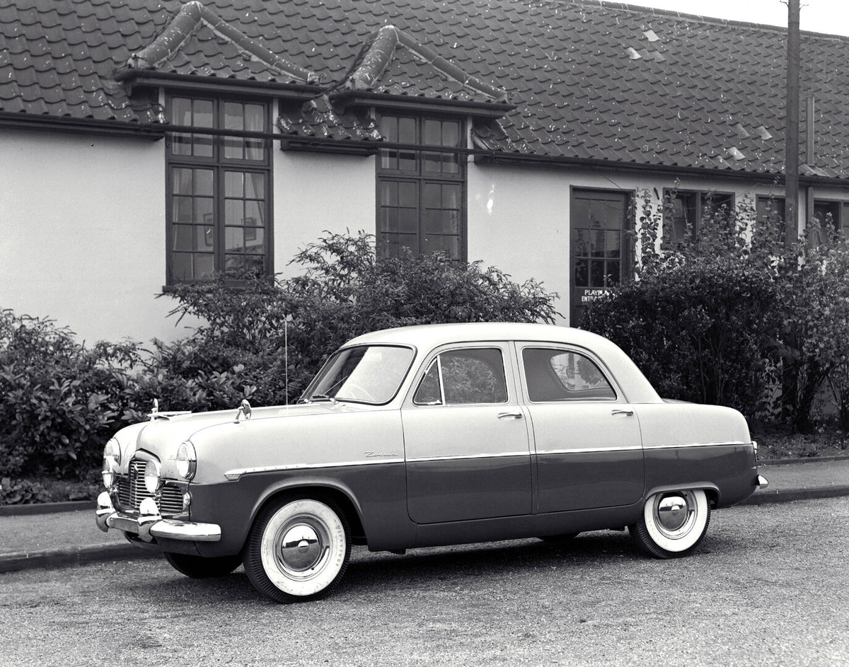 This archival image documents the 1953 Ford Zodiac Mark I on scenic road in front of house and is preserved in the Ford Heritage Vault as part of Ford Motor Company's historic photographic archive. Free for personal, non-commercial use. Ford Herit...