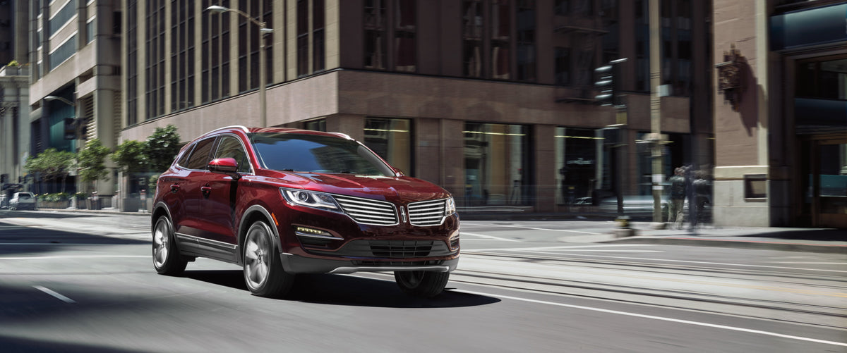 This archival image documents the 2018 Lincoln MKC action shot on city street and is preserved in the Ford Heritage Vault as part of Ford Motor Company's historic photographic archive. Free for personal, non-commercial use. Ford Heritage Vault ref...
