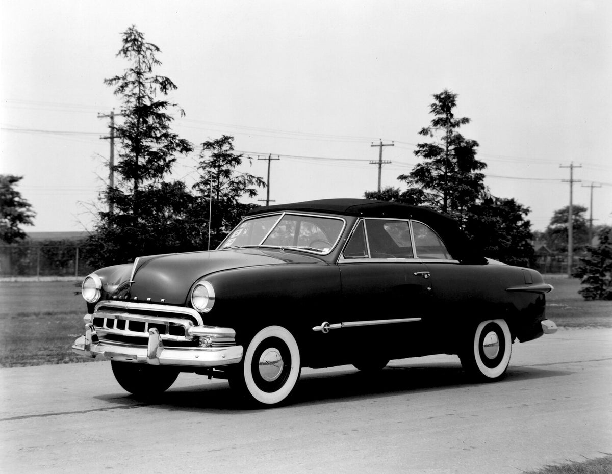 This archival image documents the 1951 Meteor Convertible on scenic road with trees AR-2007-5 and is preserved in the Ford Heritage Vault as part of Ford Motor Company's historic photographic archive. Free for personal, non-commercial use. Ford He...