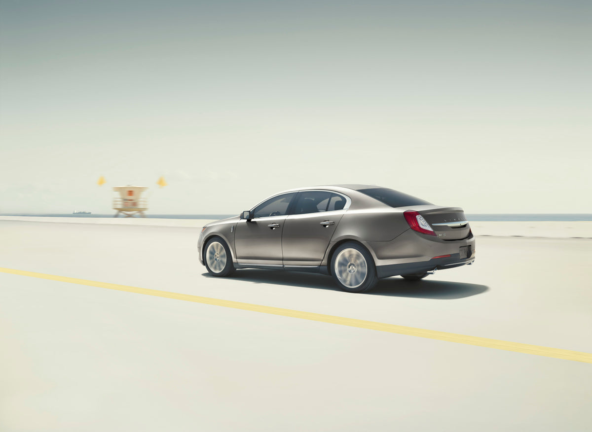 This archival image documents the 2015 Lincoln MKS action shot on scenic road and is preserved in the Ford Heritage Vault as part of Ford Motor Company's historic photographic archive. Free for personal, non-commercial use. Ford Heritage Vault ref...