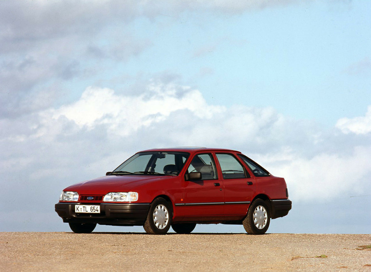 This archival image documents the 1989 Ford Sierra with scenic blue sky and is preserved in the Ford Heritage Vault as part of Ford Motor Company's historic photographic archive. Free for personal, non-commercial use. Ford Heritage Vault reference...
