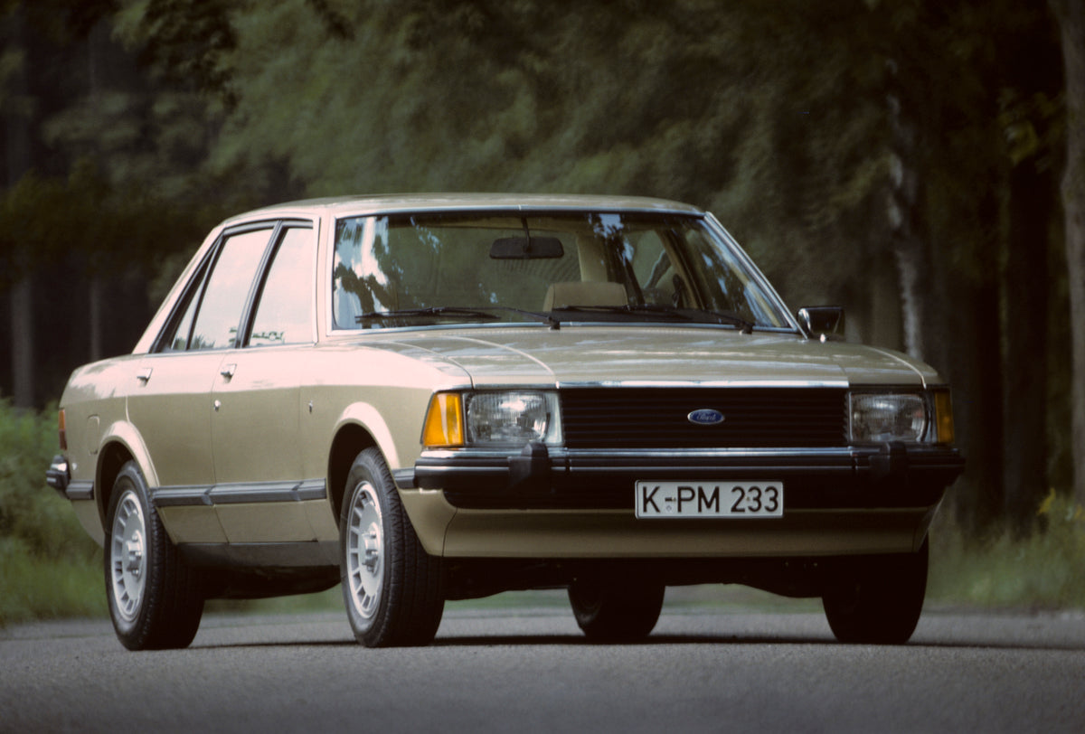 This archival image documents the 1977 Ford Granada Mark II Ghia on scenic road with trees and is preserved in the Ford Heritage Vault as part of Ford Motor Company's historic photographic archive. Free for personal, non-commercial use. Ford Herit...