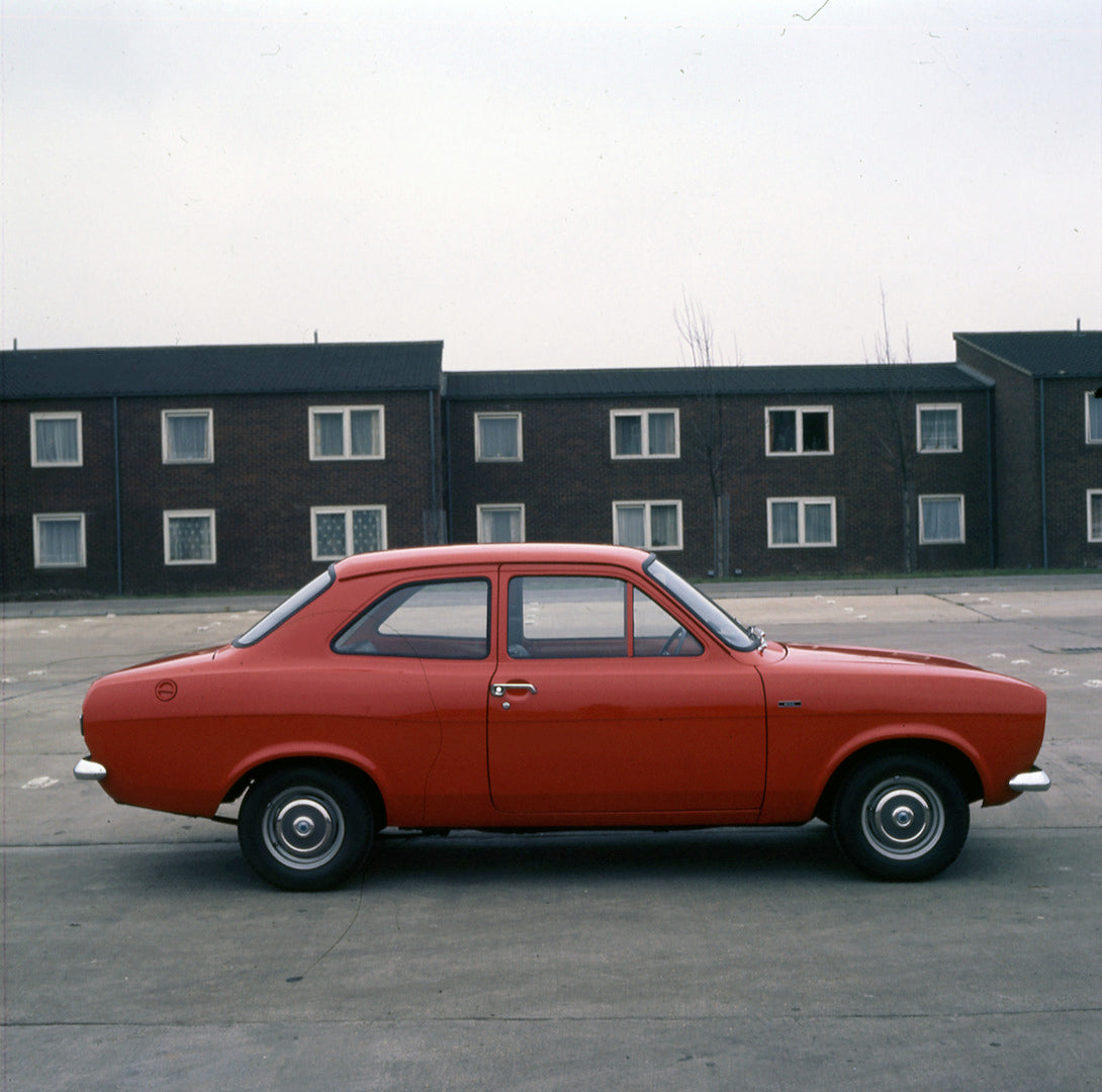 This archival image documents the 1974 Ford Escort Mark II 1100 side view in front of building 1973-203 and is preserved in the Ford Heritage Vault as part of Ford Motor Company's historic photographic archive. Free for personal, non-commercial us...